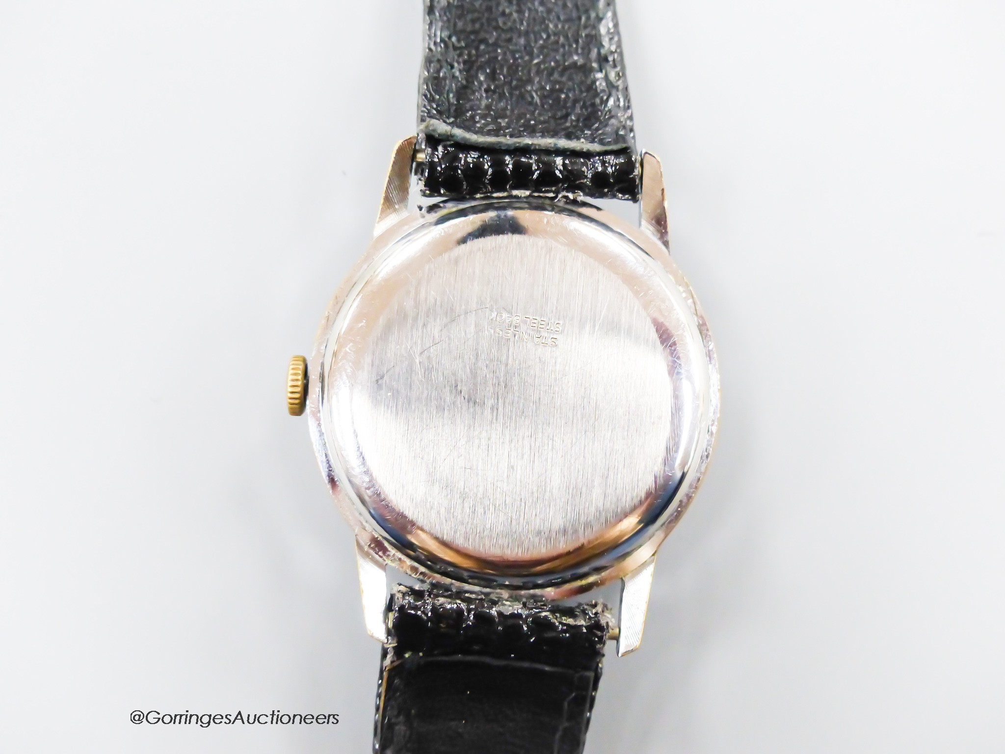 A gentleman's early 1940's stainless steel Omega manual wind wrist watch, case diameter 34mm, on later associated strap.